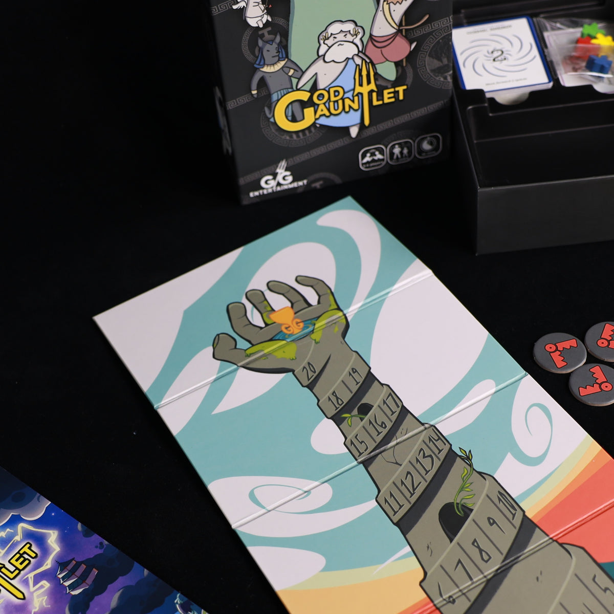 God Gauntlet box and tower game board on a table